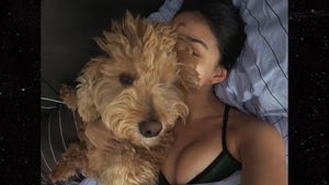 0911-Rachel-Zegler-Dog-Cuddle-PRIMARY