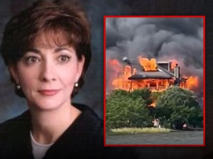 Judge Diane Goodstein is seen next to a photo of her burning home in South Carolina. She's wearing a black jacket.