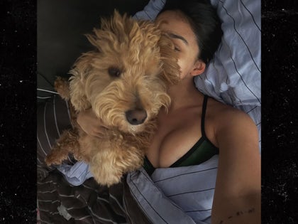 0911-Rachel-Zegler-Dog-Cuddle-PRIMARY