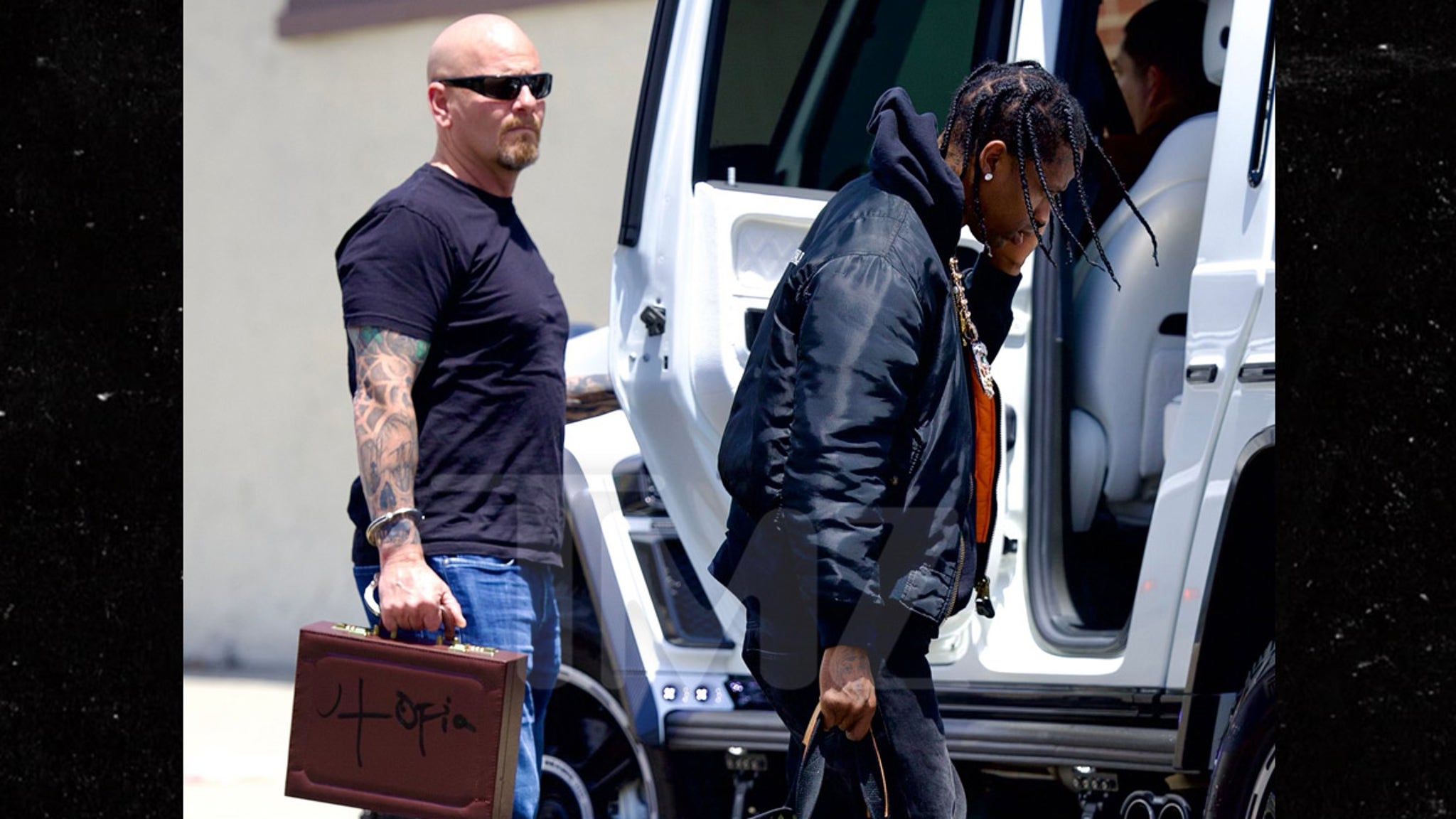 Travis Scott and the security guard seen with ‘Utopia’ album handcuffs on the wrists