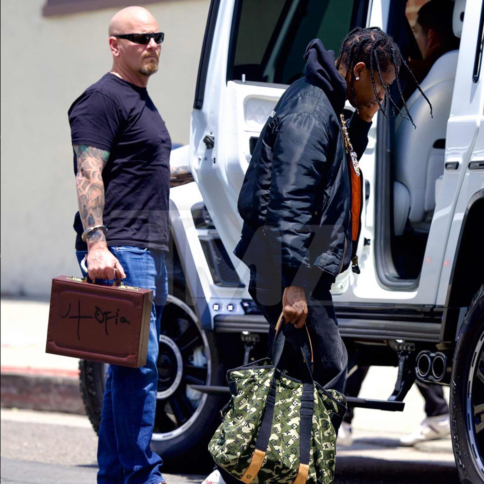 Travis Scott and Security Guard Seen with 'Utopia' Album