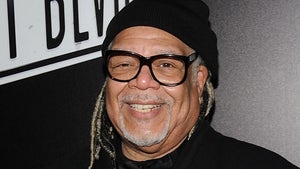 Ken Page Smiling With A Beanie And Glasses On