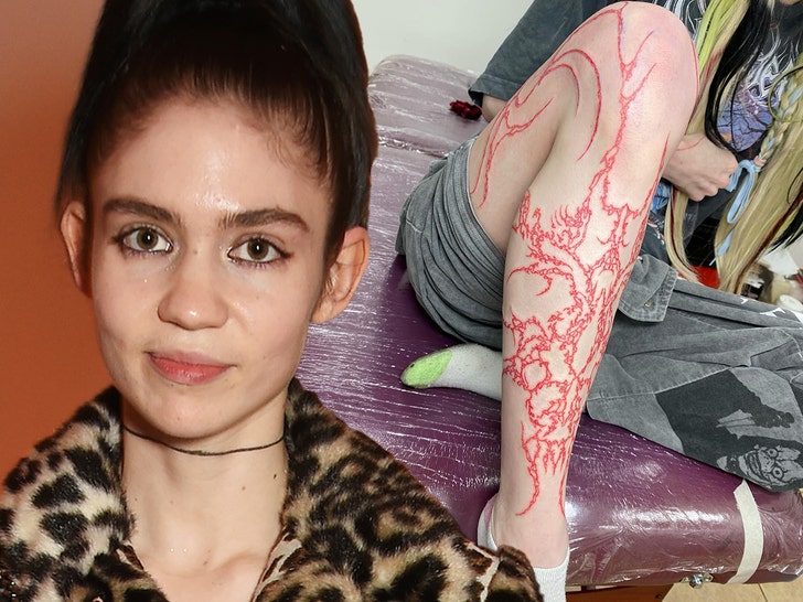 Grimes Gets Full-Length Leg Tattoo In Red Ink