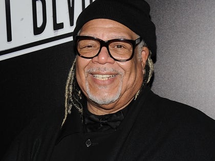 Ken Page Smiling With A Beanie And Glasses On