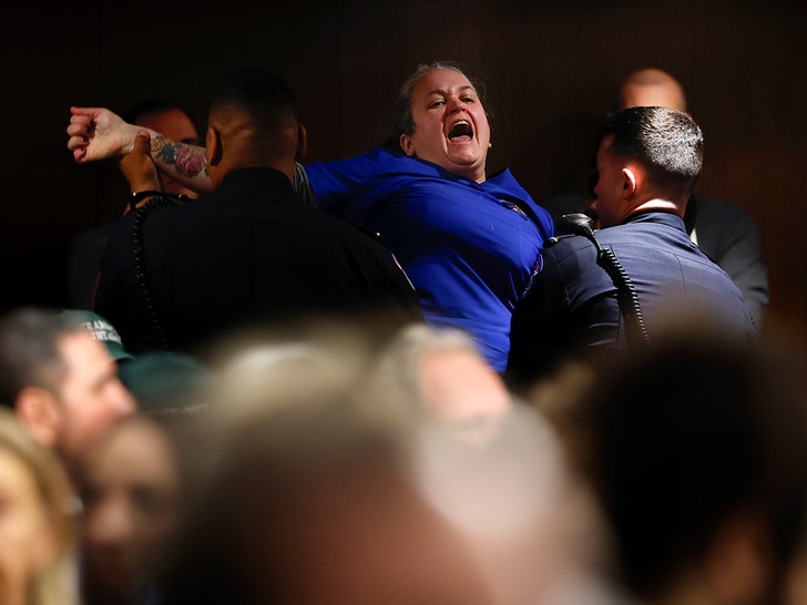 US Capitol Police officers remove a protestor as Secretary of Health and Human Services nominee Robert F. Kennedy Jr. testifies during a Senate Finance Committee hearing