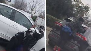 022726_man_hanging_from_cars_primary