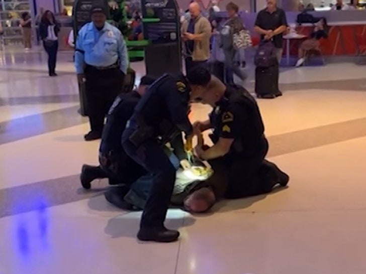 112124-man-tased-pinned-down