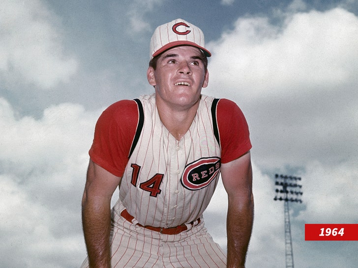 Pete Rose in a white pinstriped Cincinnati Reds uniform, leaning toward the trash.