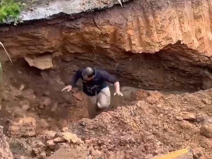 091025_thailand_road_collapse__man_fall_primary