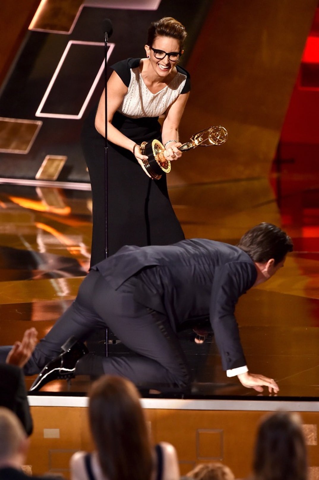 Jon Hamm falls accepting Outstanding Lead Actor in a Drama Series award for 'Mad Men' from actress Tina Fey -- 67th Annual Primetime Emmy Awards