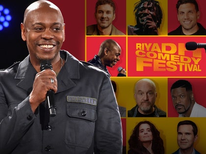 Dave Chappelle is smiling next to a poster for the Riyadh Comedy Festival.