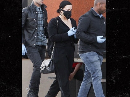 0316 Demi Lovato wears a mask as she shops at Erewhon in LA back