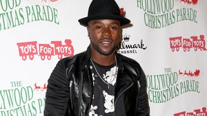 Joshua Allen is seen at what appears to be a charity event. He's wearing a leather jacket, a graphic-printed shirt, and a black hat.