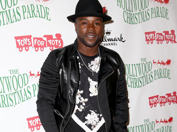 Joshua Allen is seen at what appears to be a charity event. He's wearing a leather jacket, a graphic-printed shirt, and a black hat.