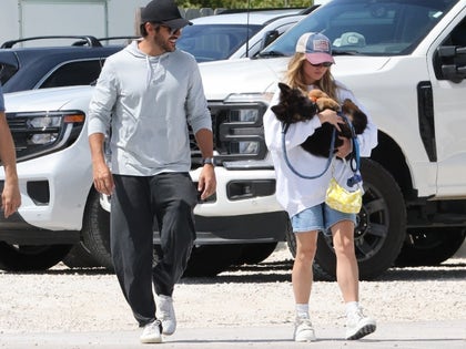 Sydney Sweeney And Jonathan Davino Walk Together While Holding A New Puppy