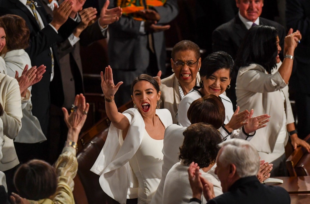 Rep. Alexandria Ocasio-Cortez (D-N.Y.) high-fives other congresswomen after President Donald J. Trump acknowledged newly elected female members of congress during the State of the Union address before members of Congress in the House chamber of the U.S. Capitol February 5, 2019 in Washington, DC.