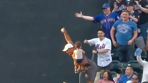 MLB Fan Makes Terrifying Over-The-Railing Catch With Baby In Hand