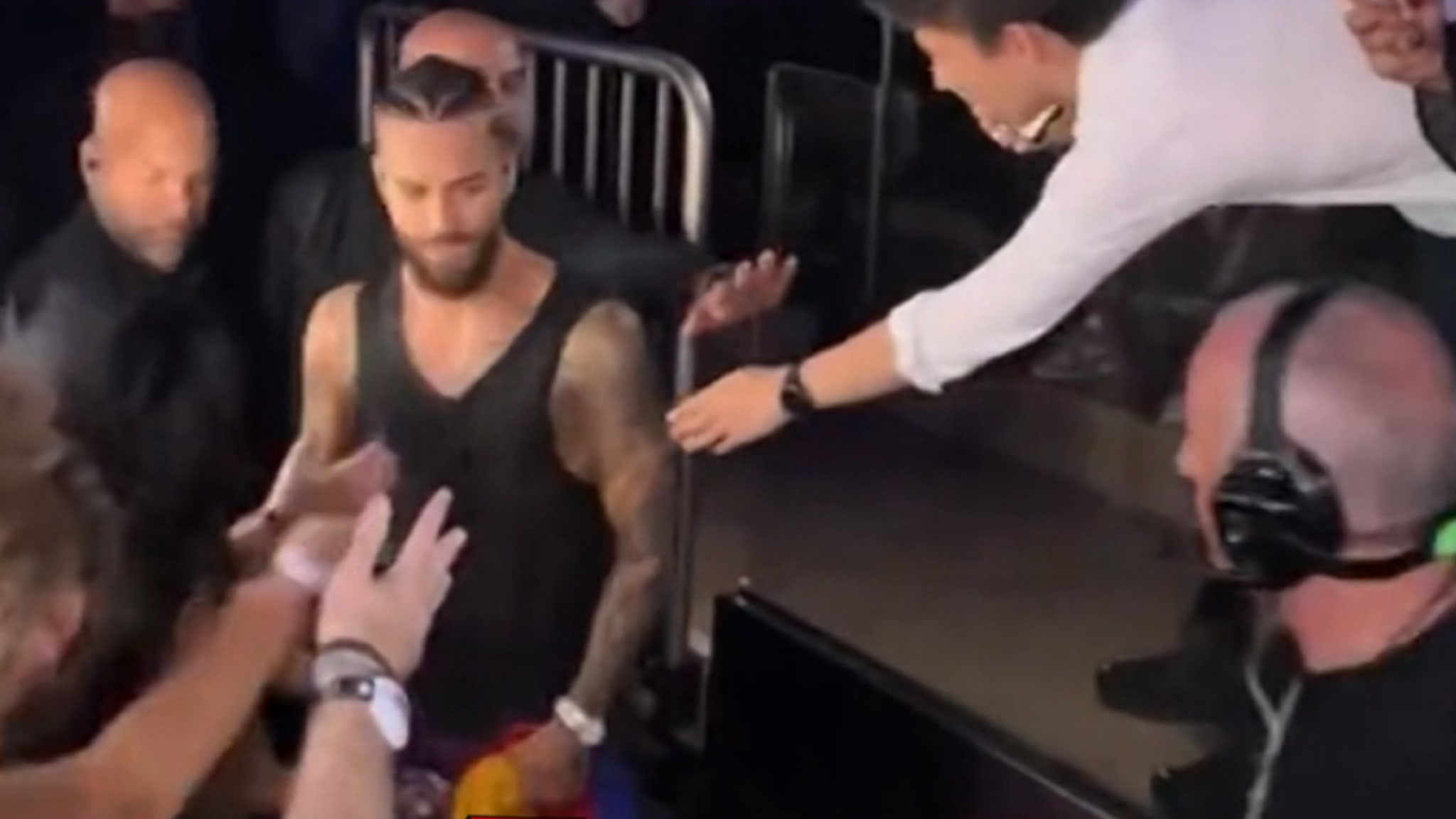 Maluma walks away from a fan after he tried to grab his crotch