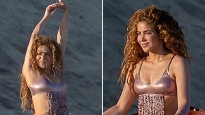 0820-Shakira-Meditates-On-Beach-Metallic-Bikini-PRIMARY