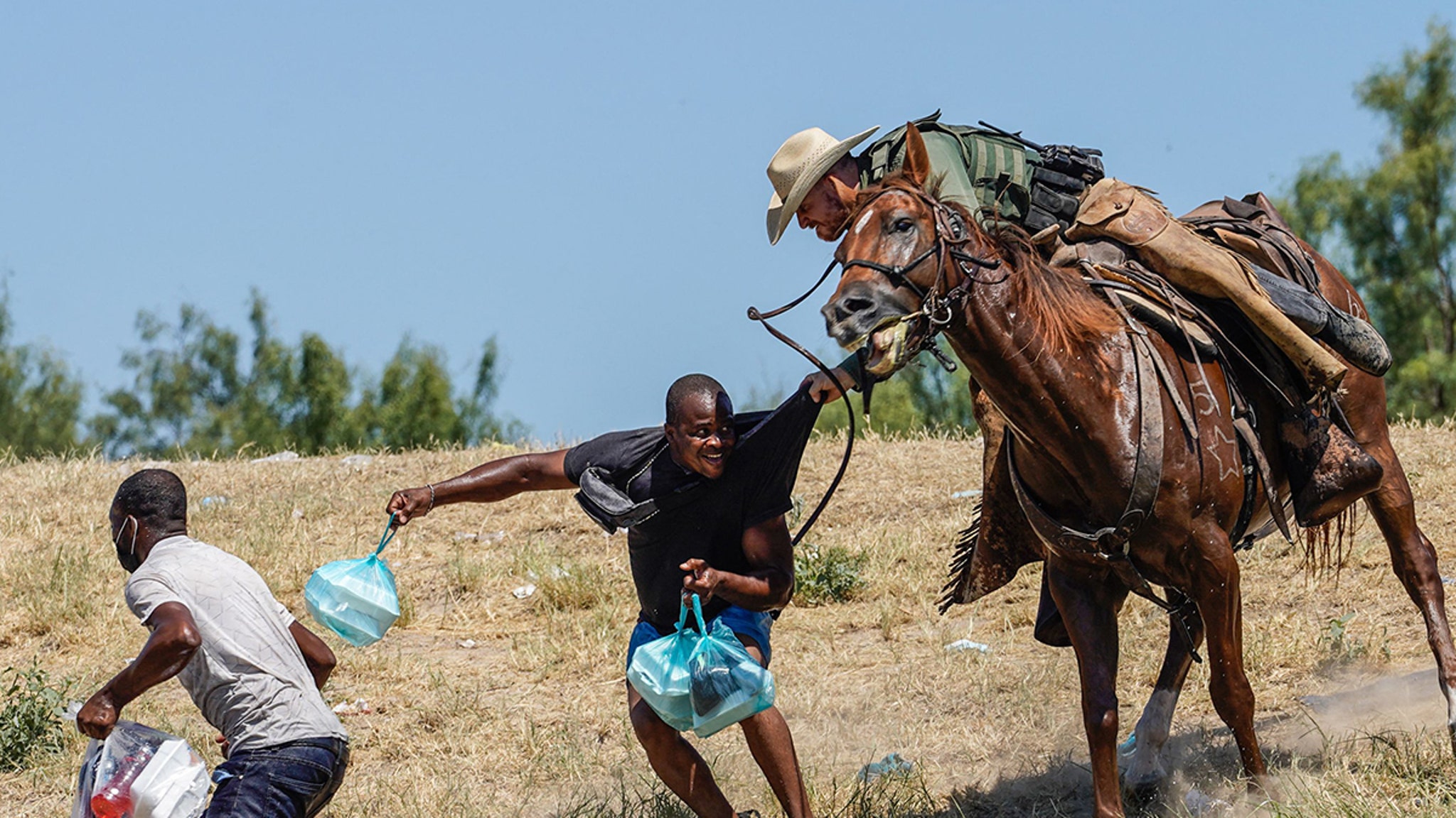 Border Patrol Agents Seem to Use Horse Reins As Whips Against Haitians