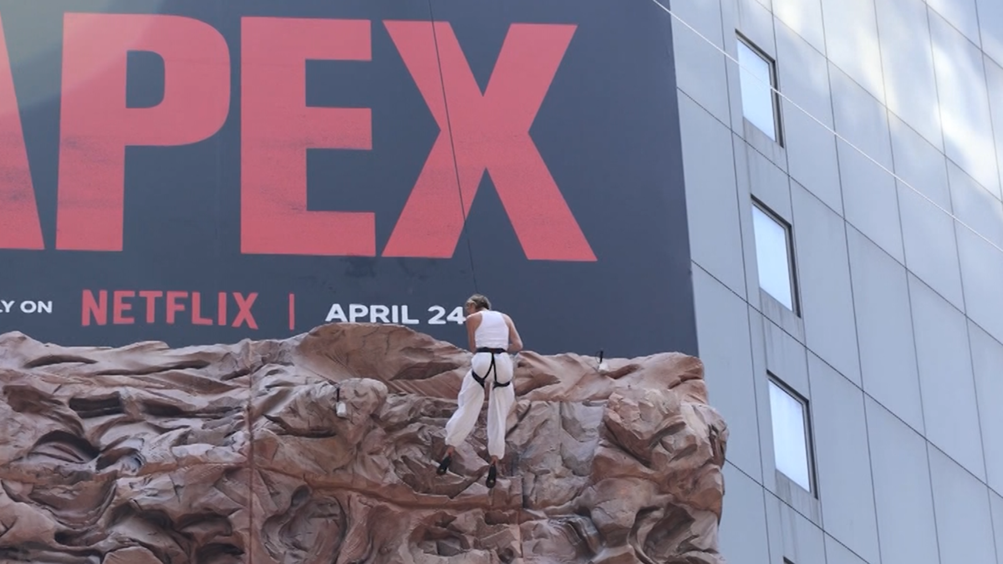 Charlize Theron Climbs the Walls of Times Square to Promote New Movie 'Apex'