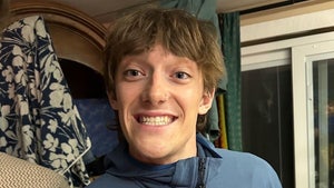 Balin Miller is seen smiling while posing for a selfie. He's wearing a blue zip-up jacket.