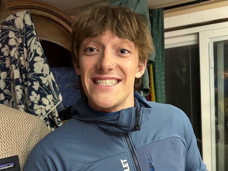 Balin Miller is seen smiling while posing for a selfie. He's wearing a blue zip-up jacket.