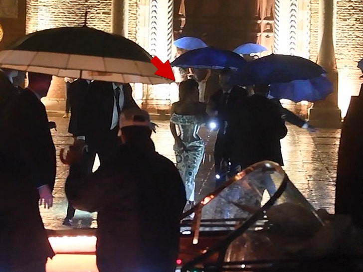 062625-bezos-sanchez-rain-umbrellas