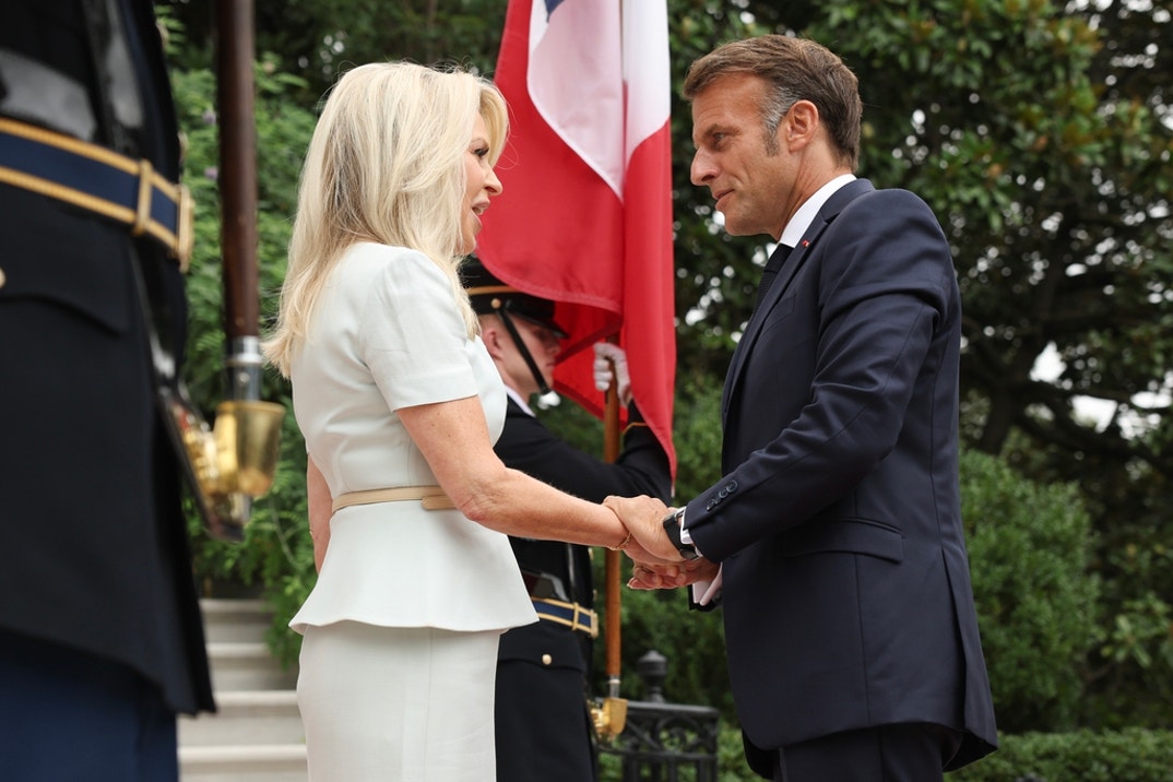 French President Emmanuel Macron (R) is greeted by U.S. Chief of Protocol Monica Crowley