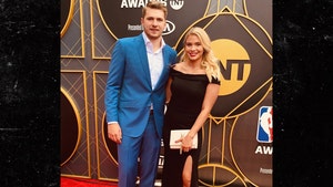Luka Doncic and his fiancee Anamaria Goltes are seen at the NBA Awards ceremony. He's wearing a blue jacket and matching pants, while she opted for a black dress,, which was offset by a white clutch.