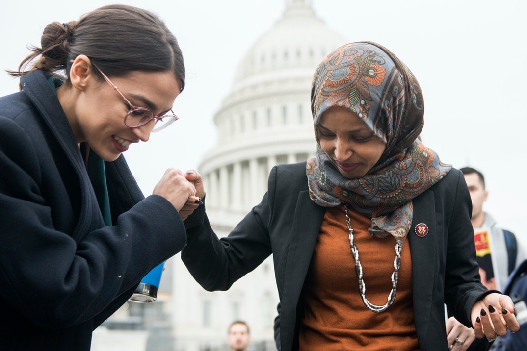 Reps. Alexandria Ocasio-Cortez, D-N.Y., left, and Ilhan Omar, D-Minn., attend a rally on the East Front of the Capitol to call on Congress to defund Immigration and Customs Enforcement (ICE) and U.S. Customs and Border Protection (CBP) .