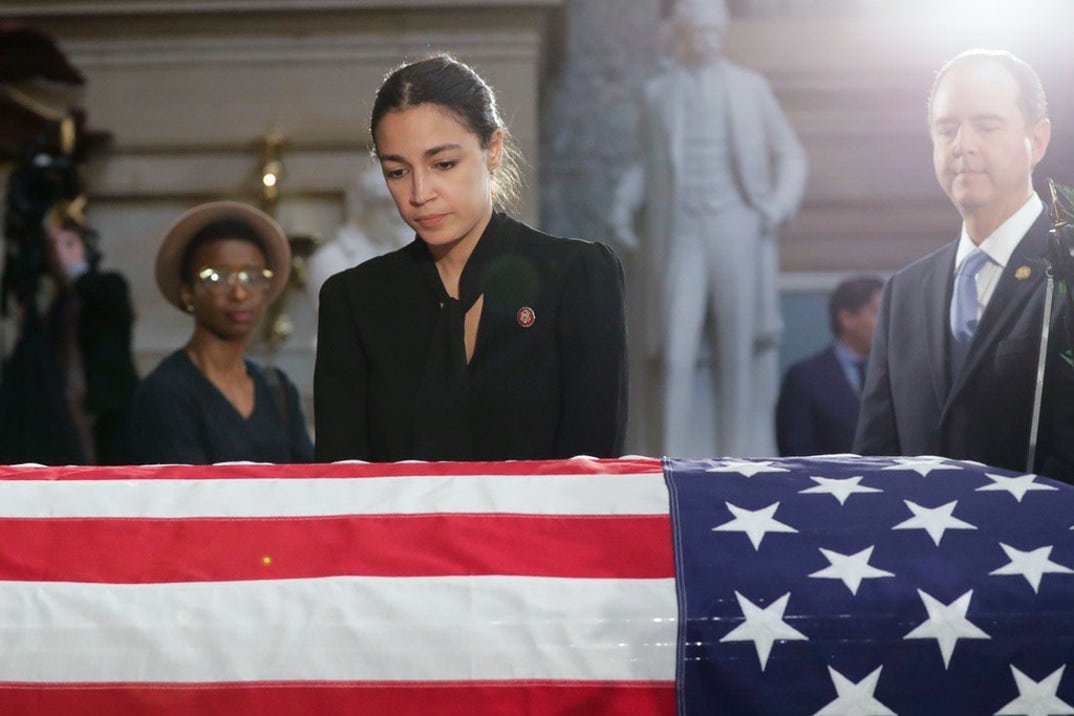 U.S. Rep. Alexandria Ocasio-Cortez (D-NY) stops to pay her respects over the flag-draped casket of U.S. Rep. Elijah Cummings (D-MD) in National Statuary Hall at the U.S. Capitol during a memorial service October 24, 2019 in Washington, DC.