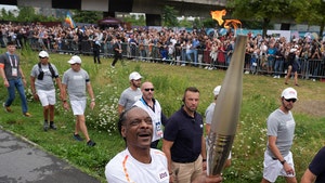Snoop Dogg Carries Olympic Torch Through Paris Suburb