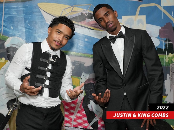 Justin and King Combs in black tie leaning over while looking at the camera.