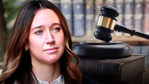 Charlie Javice is seen next to a gavel and block. She's wearing a white button-up shirt.