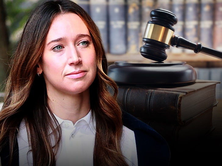 Charlie Javice is seen next to a gavel and block. She's wearing a white button-up shirt.
